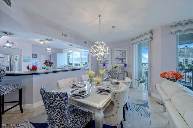 dining space with an inviting chandelier and light tile flooring