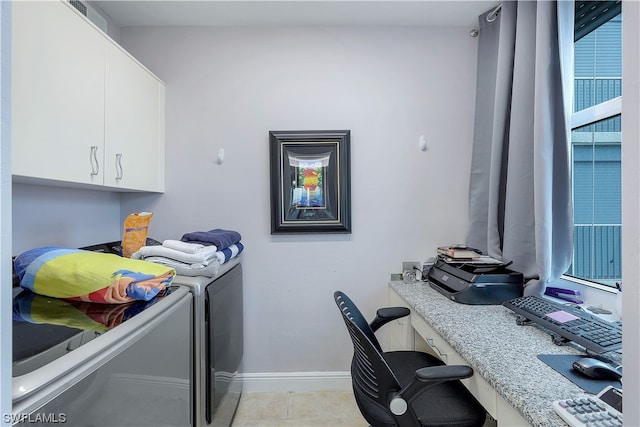 clothes washing area featuring light tile floors, cabinets, and independent washer and dryer