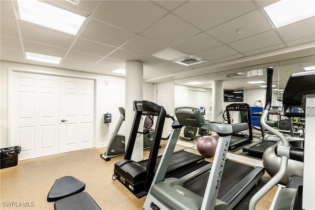 gym featuring a paneled ceiling