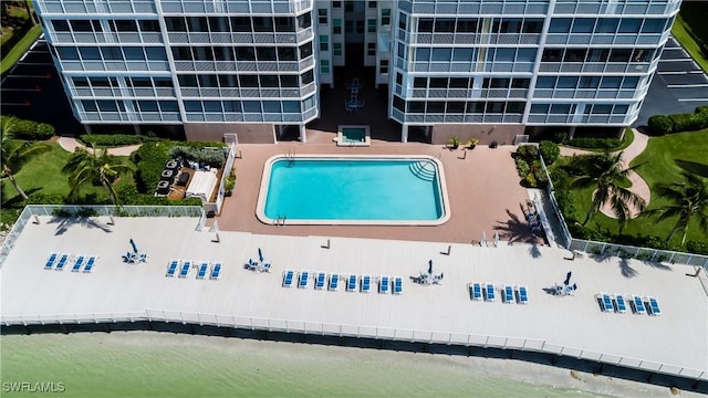 view of pool featuring a water view