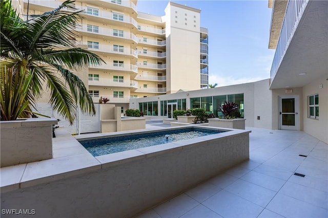 view of swimming pool with a patio area