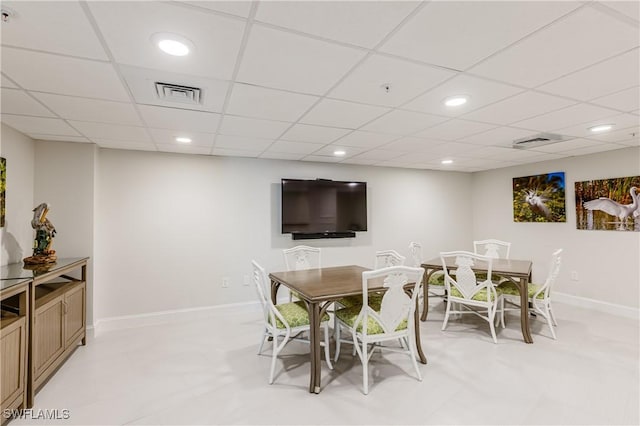 dining area featuring a paneled ceiling