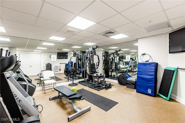 exercise room with a paneled ceiling