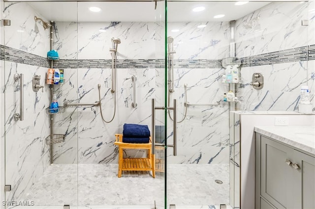 bathroom with vanity and tiled shower