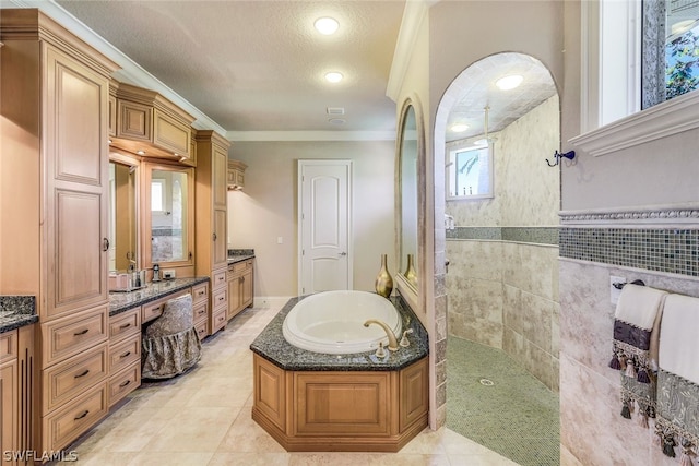 bathroom featuring tile flooring, ornamental molding, shower with separate bathtub, tile walls, and vanity