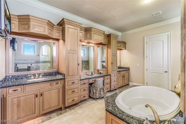 bathroom with tile flooring, ornamental molding, vanity, and a tub