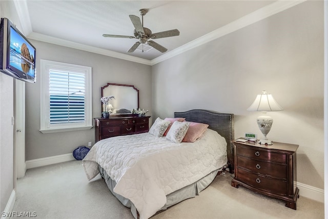 carpeted bedroom with ceiling fan and ornamental molding