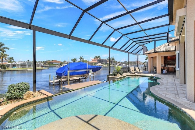 view of swimming pool with a patio, glass enclosure, a water view, and a dock