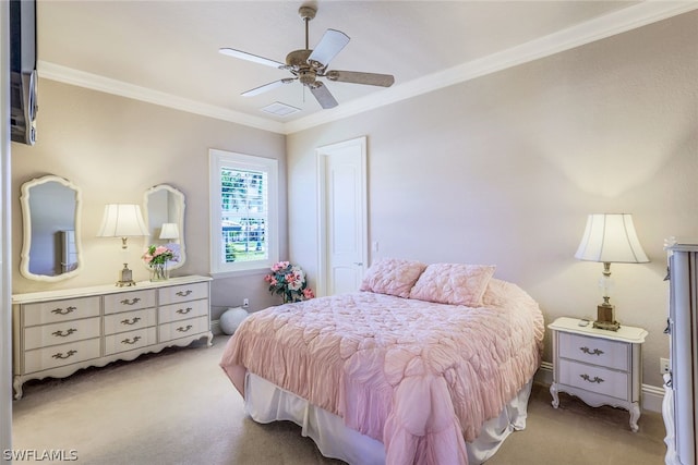 carpeted bedroom with ceiling fan and ornamental molding