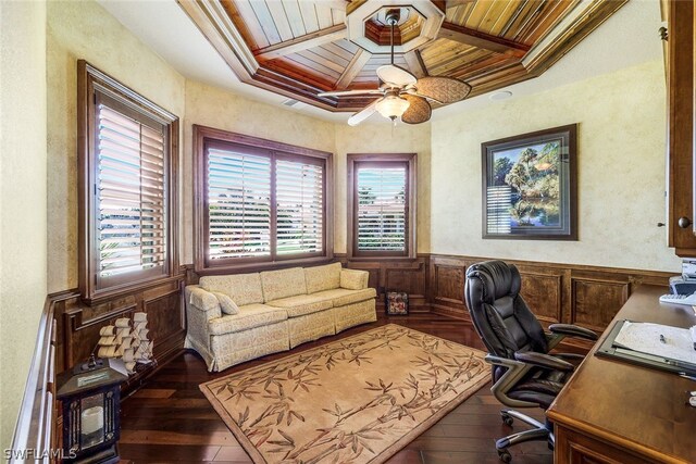 office space featuring dark hardwood / wood-style floors, ceiling fan, ornamental molding, and wooden ceiling