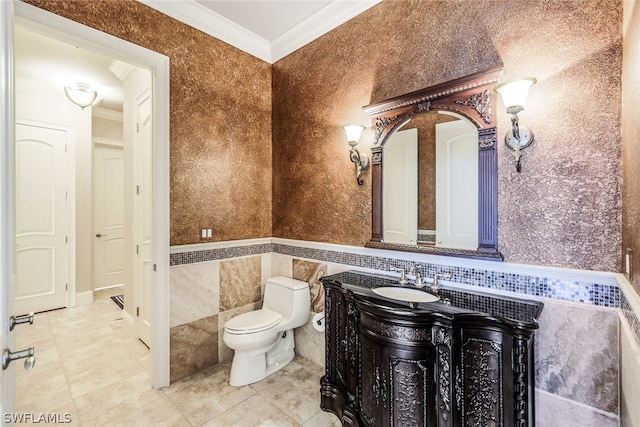 bathroom with tile walls, toilet, tile floors, and ornamental molding