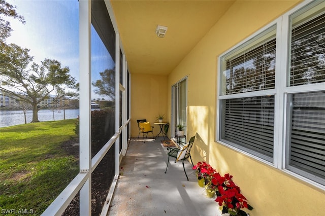 sunroom / solarium with a water view