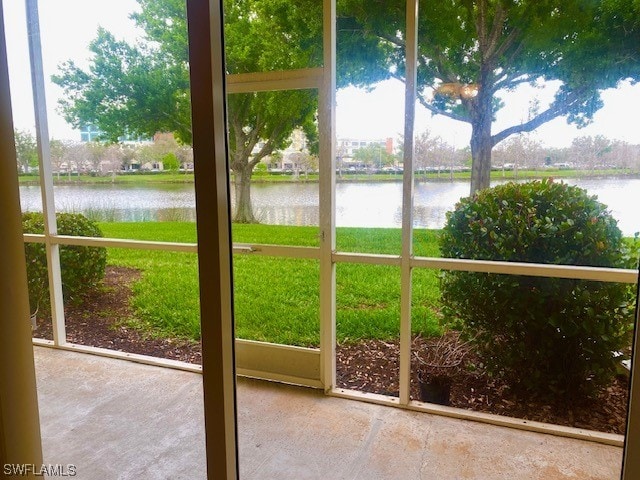 unfurnished sunroom with a water view