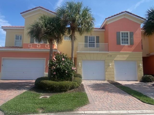 16198 Via Solera Cir Unit 102, Fort Myers, FL 33908 - view of front of home featuring a garage, a tiled roof, decorative driveway, and stucco siding
