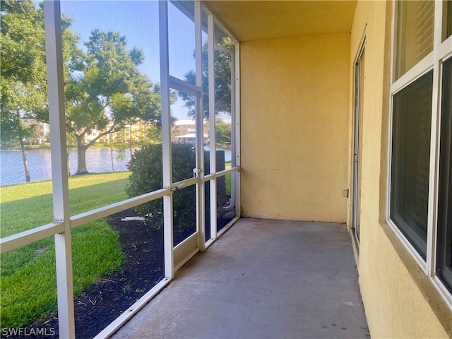 unfurnished sunroom with a water view