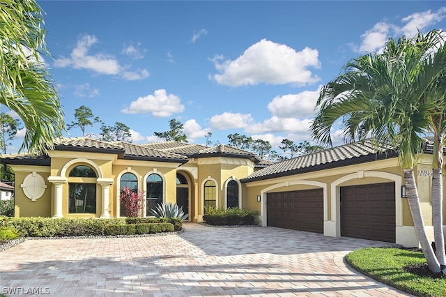 mediterranean / spanish-style home featuring a garage