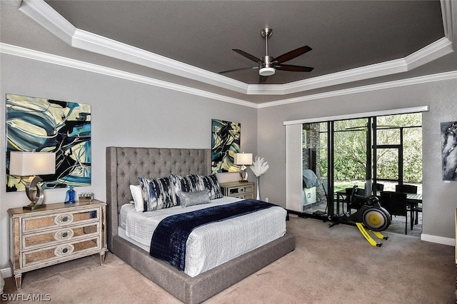 carpeted bedroom featuring access to exterior, a raised ceiling, ceiling fan, and crown molding