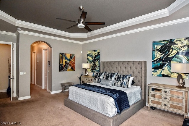 bedroom with crown molding, a tray ceiling, ceiling fan, and carpet floors