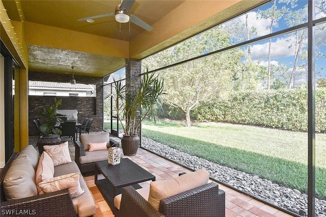 sunroom featuring ceiling fan