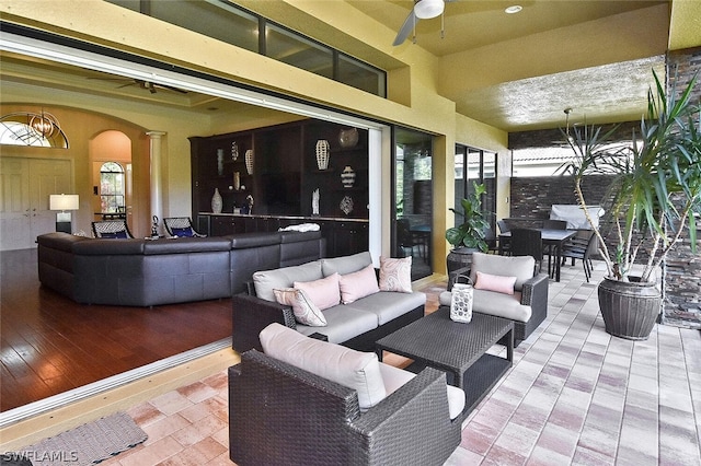 view of terrace with outdoor lounge area and ceiling fan