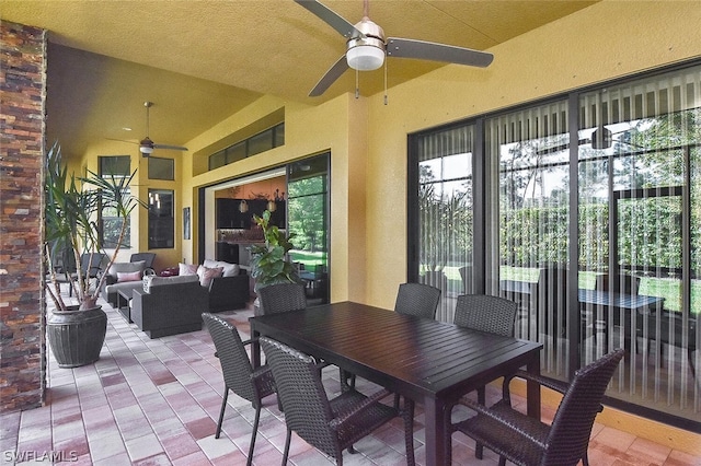 view of terrace with an outdoor living space and ceiling fan