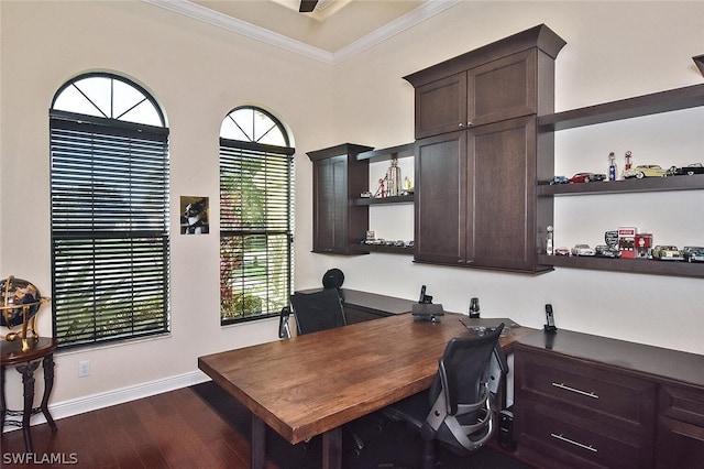 office area with built in desk, dark wood-type flooring, and crown molding