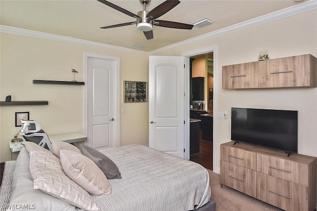 carpeted bedroom with ornamental molding and ceiling fan