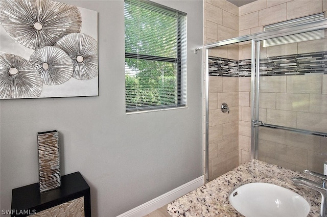 bathroom with an enclosed shower and vanity