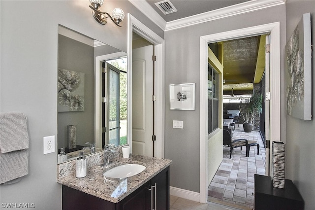 bathroom featuring vanity, tile floors, and ornamental molding