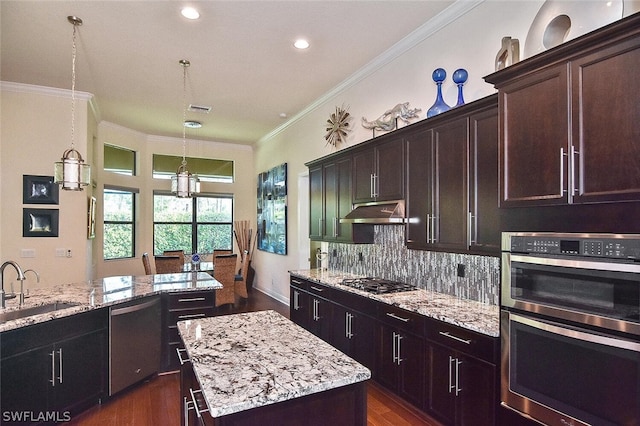 kitchen with appliances with stainless steel finishes, backsplash, light stone counters, and dark hardwood / wood-style floors