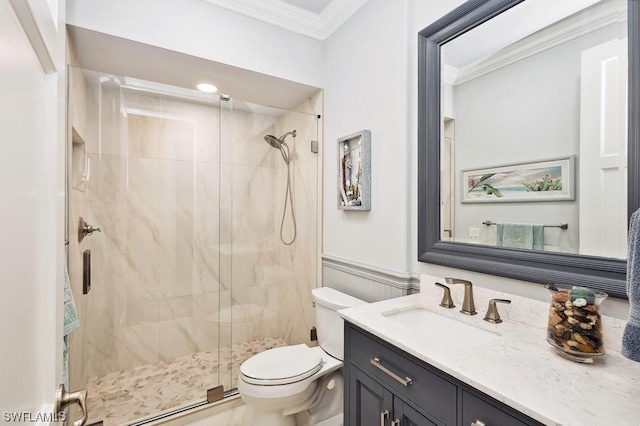 bathroom featuring a shower with door, crown molding, vanity, and toilet