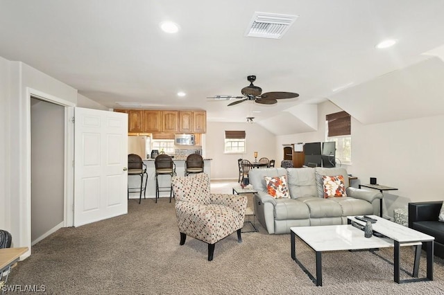 living room featuring lofted ceiling, light carpet, and ceiling fan