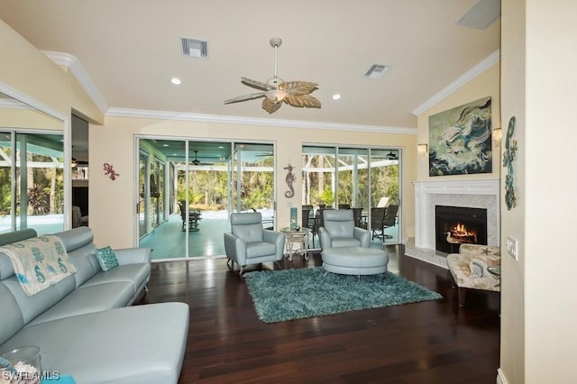 living room featuring ornamental molding, a premium fireplace, ceiling fan, and dark hardwood / wood-style flooring