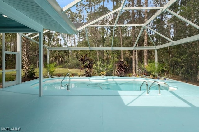 view of pool with glass enclosure