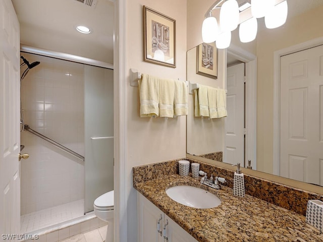 bathroom featuring recessed lighting, a shower stall, toilet, and vanity