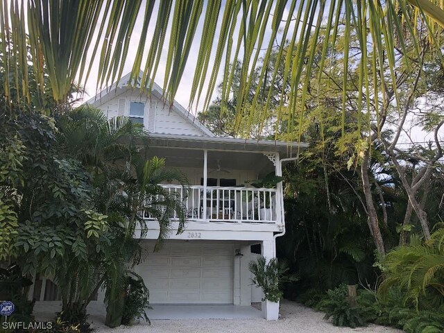 exterior space with ceiling fan and a garage