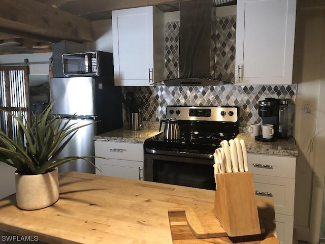 kitchen featuring backsplash, white cabinetry, wall chimney exhaust hood, and appliances with stainless steel finishes