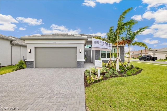 view of front of property with a garage, stone siding, decorative driveway, a front lawn, and stucco siding