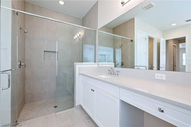 full bathroom featuring recessed lighting, visible vents, vanity, a shower stall, and tile patterned flooring