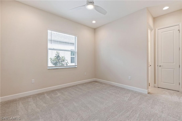 empty room with baseboards, recessed lighting, a ceiling fan, and light colored carpet