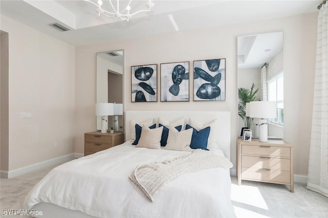 bedroom featuring a chandelier, light colored carpet, visible vents, and baseboards