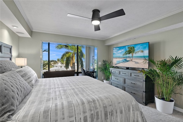 carpeted bedroom featuring ornamental molding, ceiling fan, and a textured ceiling