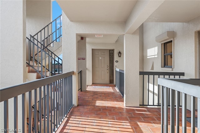 view of exterior entry featuring a balcony