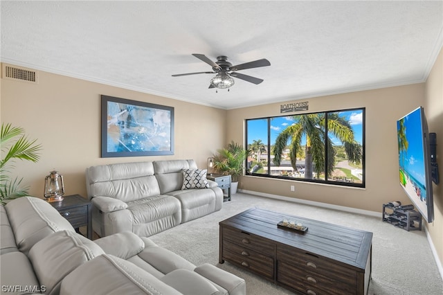 living room with light carpet, ceiling fan, a textured ceiling, and crown molding