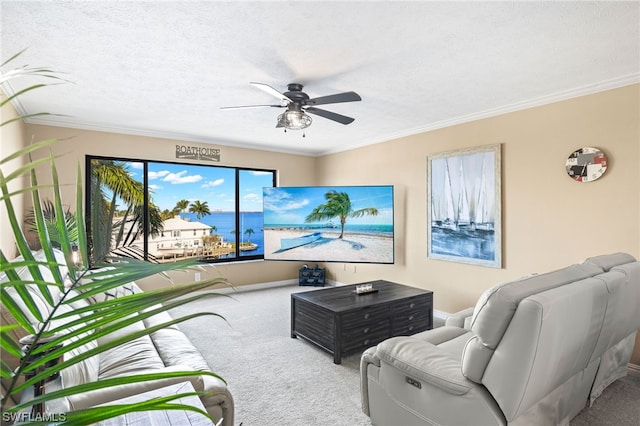 carpeted living room featuring a water view, ceiling fan, a textured ceiling, and crown molding