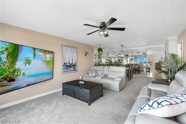 living room featuring light carpet, crown molding, and ceiling fan