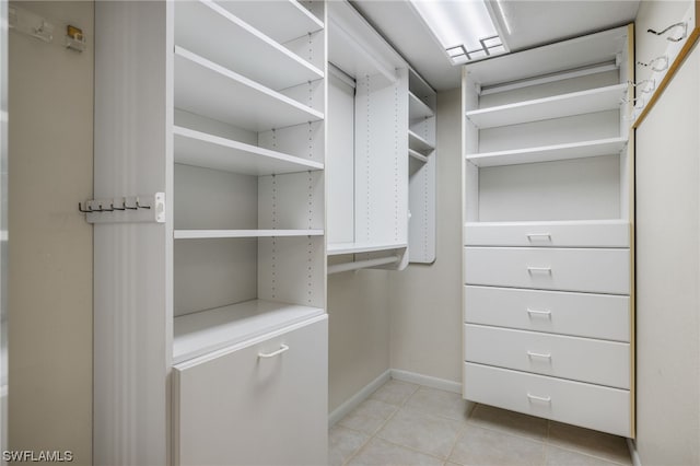 spacious closet featuring light tile flooring