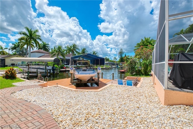 exterior space with a water view, a boat dock, and glass enclosure