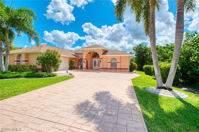 mediterranean / spanish home featuring a front yard