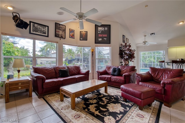 living room featuring light tile floors, ceiling fan, and high vaulted ceiling